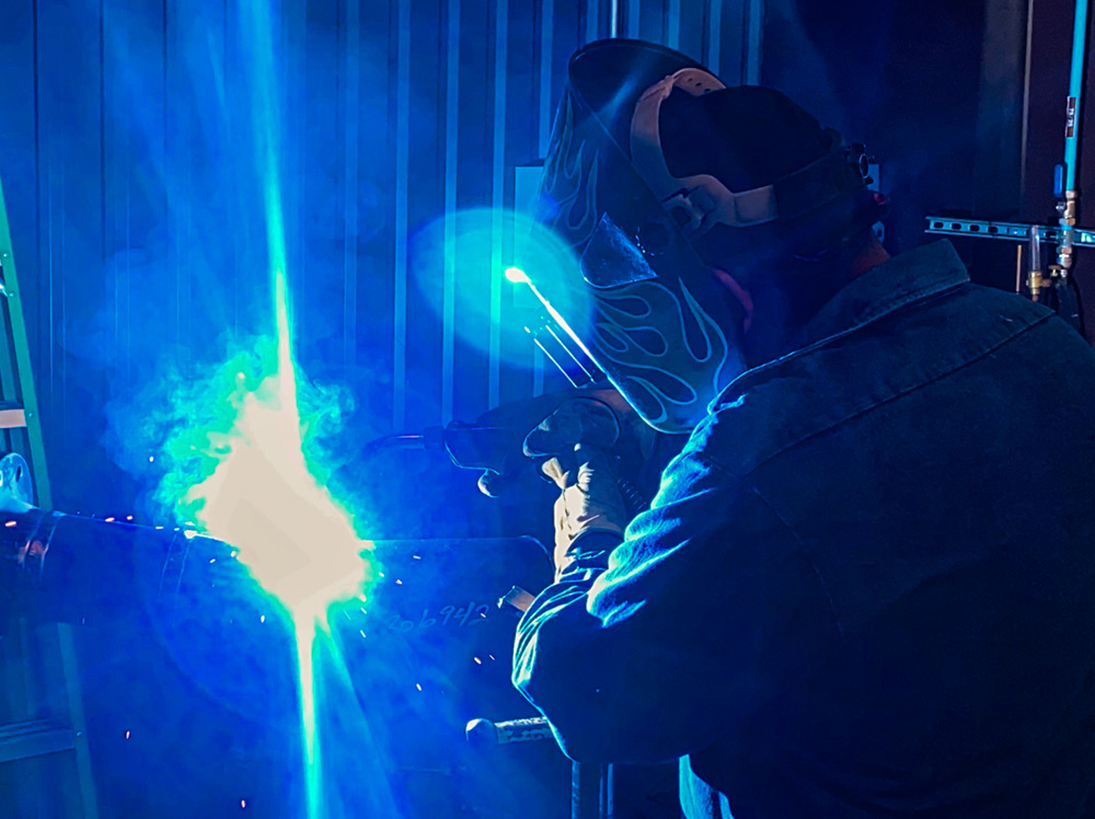A Crest Water Solutions welder using approved safety methods.